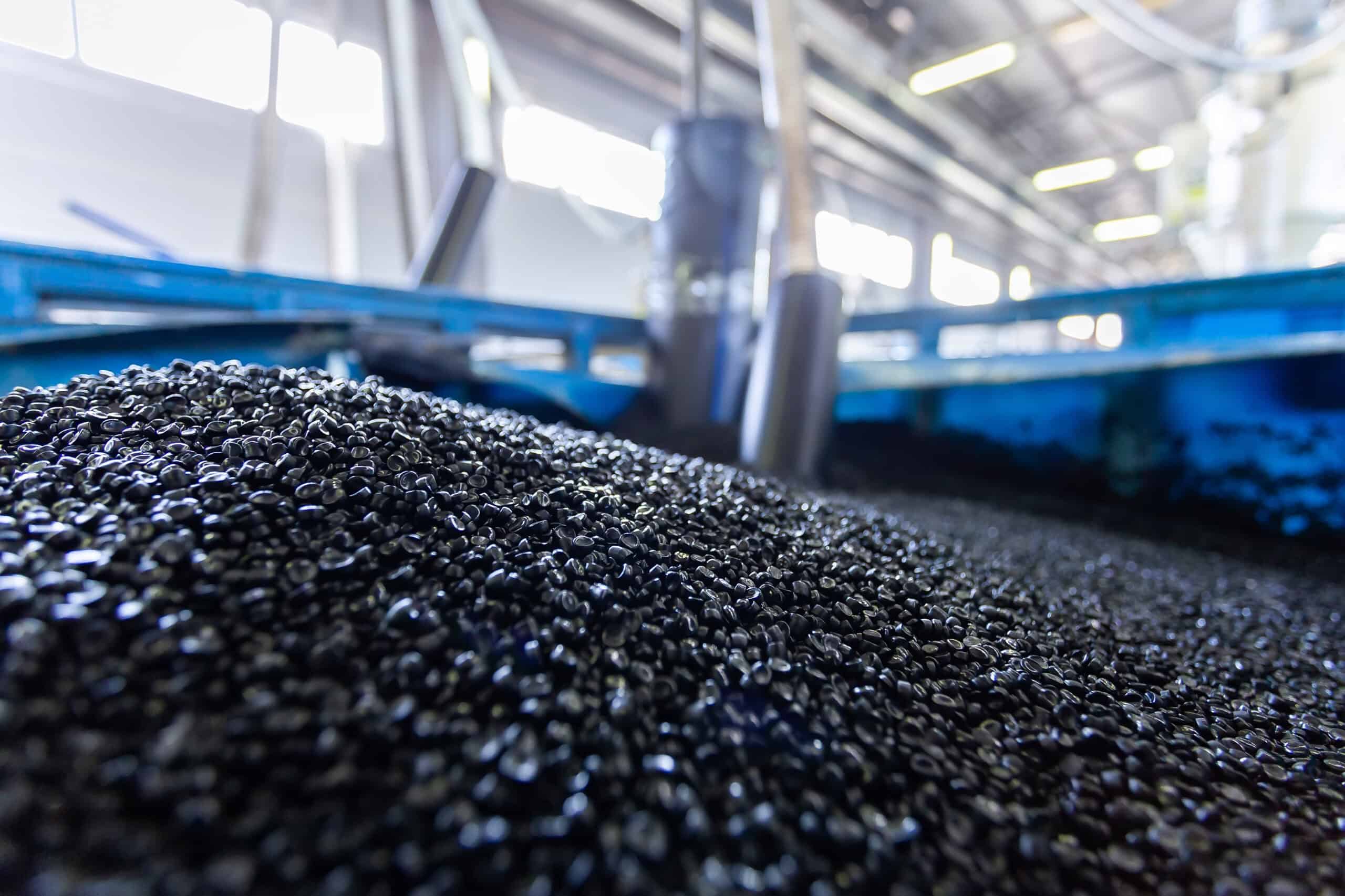 Black plastic pellets in manufacturing process at Kelco Industries facility.