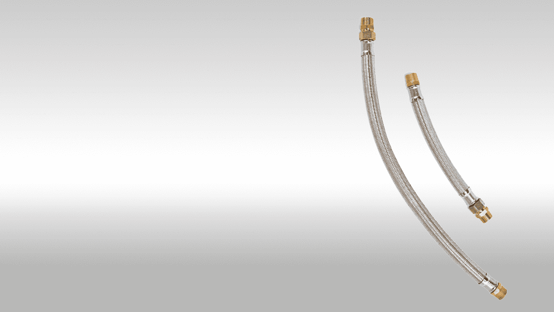 Flexible stainless steel hydraulic hoses with brass fittings for industrial applications.