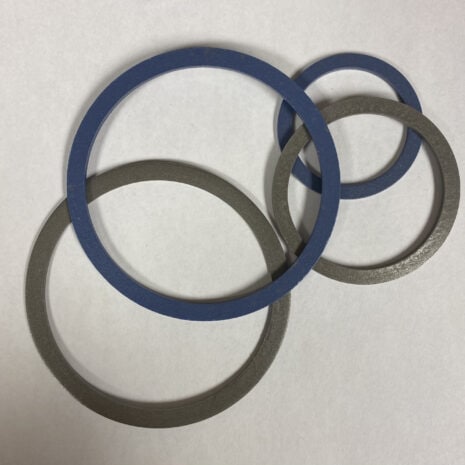Sealing washers for industrial machinery, blue and gray rubber gaskets for reliable sealing.