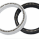 White and black precision bearing rings for industrial machinery.