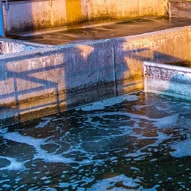 Water treatment facility with filtration tanks and clean water flow.